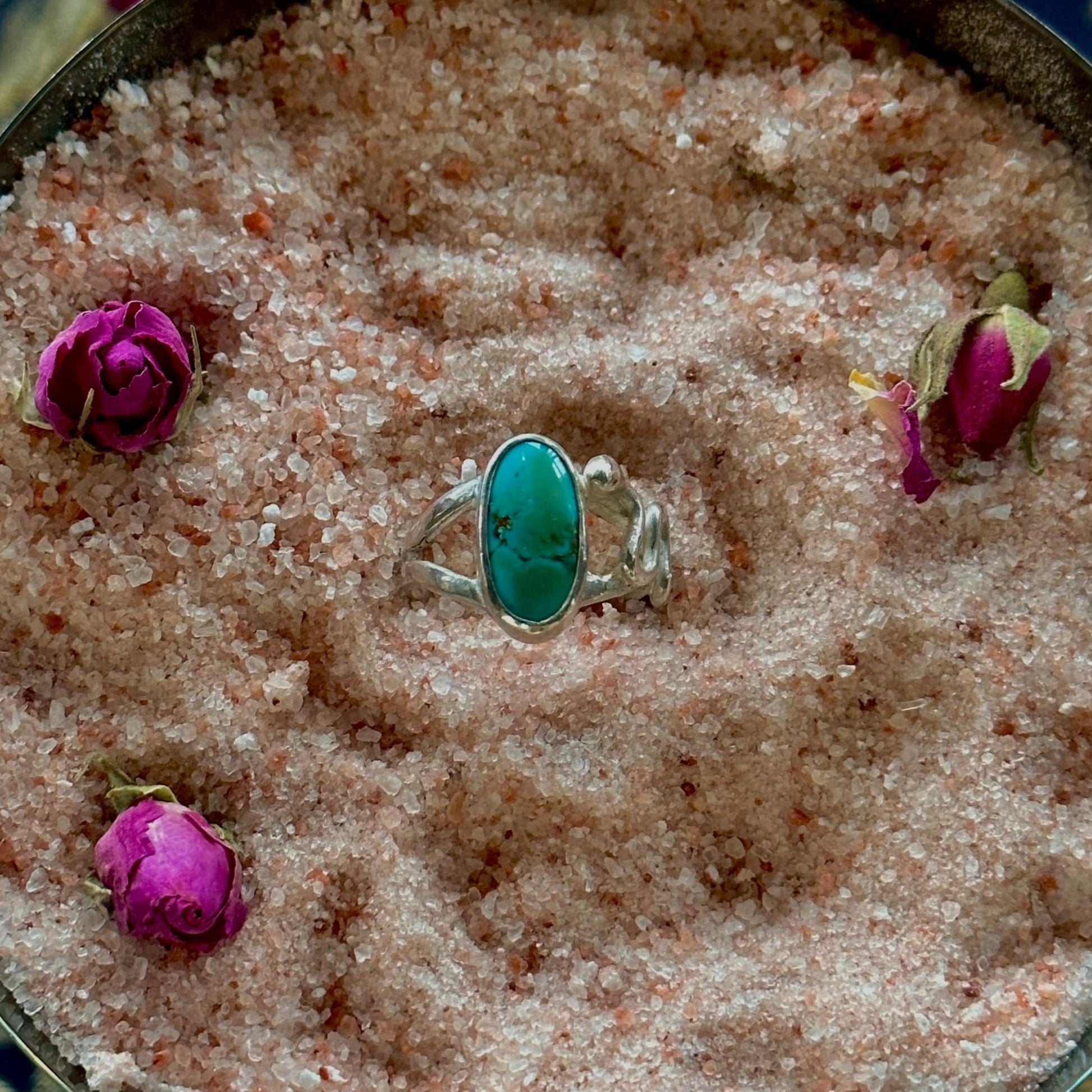 handmade silver ring witha split shank band. Snake crawling up one side of the ring 